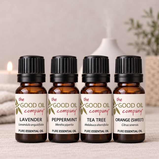 Everyday Essentials Starter Kit with four 10ml bottles of Lavender, Peppermint, Tea Tree and Sweet Orange, with soft-focus diffuser and linen in the background.